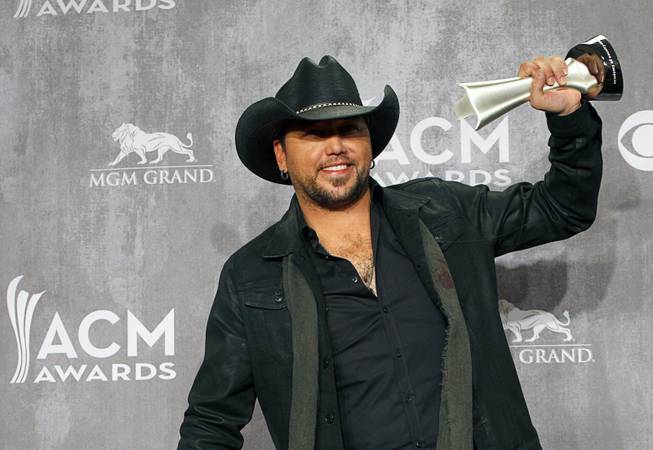 Jason Aldean holds his trophy for Male Vocalist of the Year, in the photo room during the 49th Academy of Country Music Awards at the MGM Grand Garden Arena Sunday, April 6, 2014.