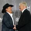 George Strait, Entertainer of the Year, greets Dallas Cowboys owner Jerry Jones in the photo room during the 49th Academy of Country Music Awards at the MGM Grand Garden Arena Sunday, April 6, 2014. The 2015 ACMA show will be held at the AT&T Stadium in Texas.