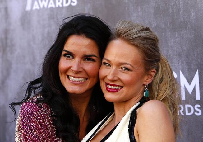 Actress Angie Harmon, left, and singer Jewel arrive for the 49th Academy of Country Music Awards show at the MGM Grand Garden Arena Sunday, April 6, 2014.