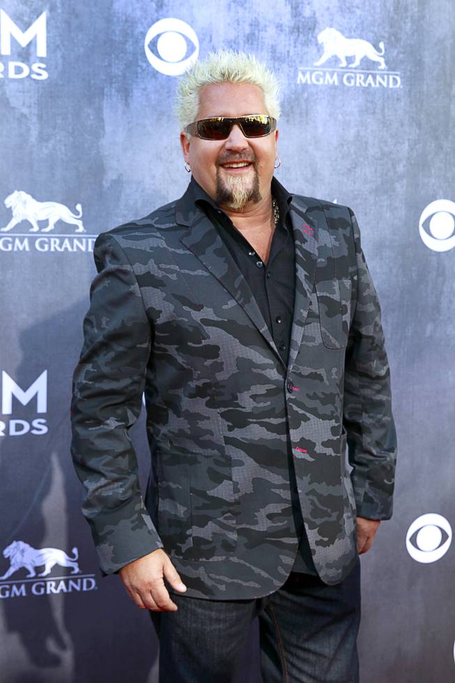 Television personality Guy Fieri arrives for the 49th Academy of Country Music Awards show at the MGM Grand Garden Arena Sunday, April 6, 2014.