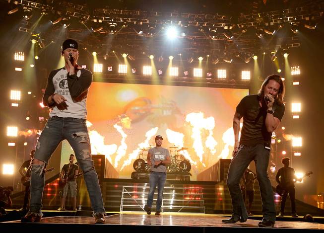 Co-host Luke Bryan, center, and Florida Georgia Line members Brian Kelley and Tyler Hubbard rehearse onstage for the ACM Fan Jam on Saturday, April 5, 2014, at Mandalay Bay Events Center.