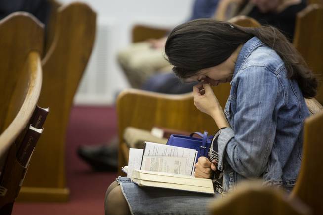 Kathy Abad, a military wife, prays for the victims and families affected by the Fort Hood shooting during a memorial service at the Tabernacle Baptist Church on Sunday, April 6, 2014, in Killeen, Texas. On April 2, 2014, three people were killed and 16 were wounded when a gunman opened fire before taking his own life at the Fort Hood military base.