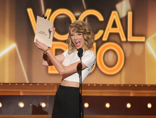 Taylor Swift presents the vocal duo of the year award to Florida Georgia Line at the 49th annual Academy of Country Music Awards at the MGM Grand Garden Arena on Sunday, April 6, 2014, in Las Vegas. 