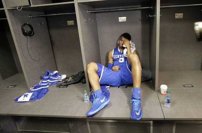 Kentucky guard Andrew Harrison sits in the locker room after his team's 60-54 loss to Connecticut in the NCAA Final Four tournament college basketball championship game Monday, April 7, 2014, in Arlington, Texas. 