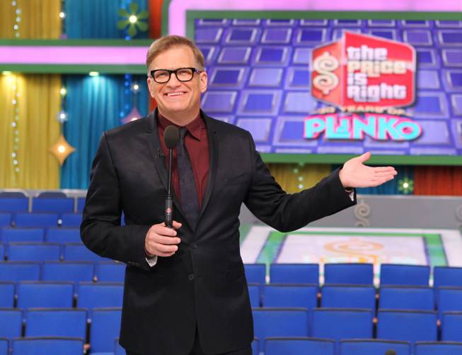 This 2013 photo released by CBS shows Drew Carey, host of "The Price Is Right," on the set in Los Angeles.
