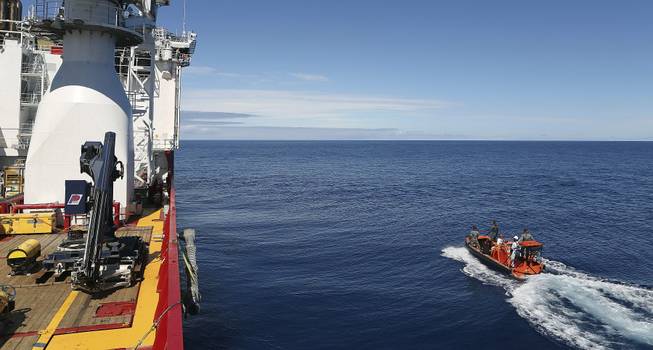 In this April 7, 2014, photo provided by the Australian Defense Force a fast response craft manned by members of the Australian Defense's ship Ocean Shield is deployed to scan the water for debris of the missing Malaysia Airlines Flight 370 in the southern Indian Ocean.