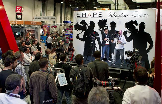 A team from Shape Camera Equipment show off their camera rigs before a large crowd at the National Association of Broadcasters show in the Las Vegas Convention Center on Tuesday, April 8, 2014.