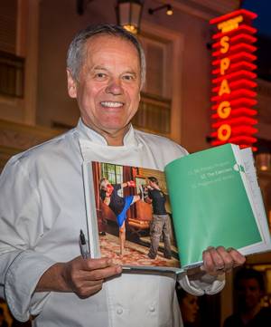 Wolfgang Puck signs copies of his newly released cookbook "Wolfgang Puck Makes It Healthy: Light, Delicious Recipes and Easy Exercises for a Better Life," on Wednesday,  April 9, 2014, in front of his restaurant Spago at the Forum Shops in Caesars Palace.