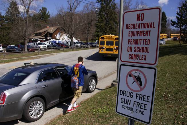 A student leaves the campus of the Franklin Regional School District where several people were stabbed at Franklin Regional High School on Wednesday, April 9, 2014, in Murrysville, Pa., near Pittsburgh. The suspect, a male student, was taken into custody and being questioned. 