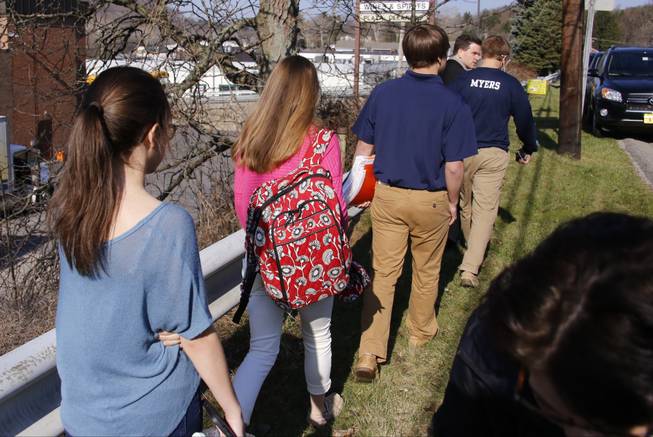 Students leave the campus of the Franklin Regional School District where several people were stabbed at Franklin Regional High School on Wednesday, April 9, 2014, in Murrysville, Pa., near Pittsburgh. The suspect, a male student, was taken into custody and being questioned.
