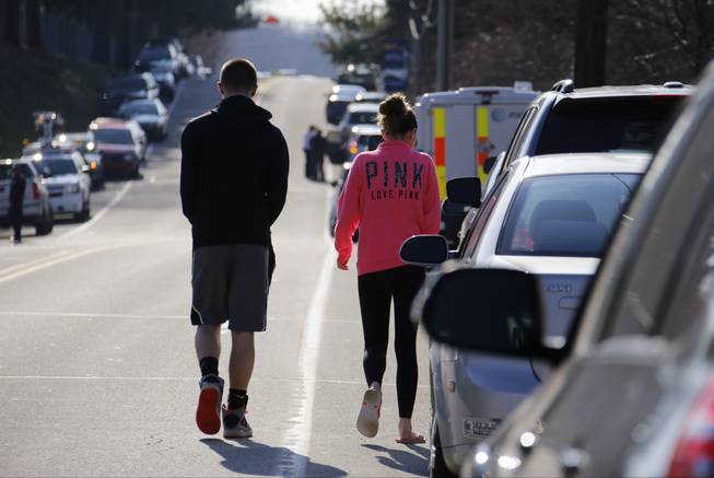 Studentswalk down the street away from the campus of the Franklin Regional School District, where several people were stabbed at Franklin Regional High School, on Wednesday, April 9, 2014, in Murrysville, Pa., near Pittsburgh. The suspect, a male student, was taken into custody and being questioned.