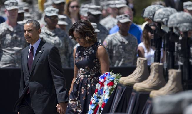 President Barack Obama and first lady Michelle Obama arrive for a memorial ceremony, Wednesday, April 9, 2014, at Fort Hood Texas, for those killed there in a shooting last week.