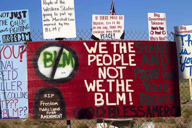 Signs are shown on a fence during a protest in support of the Bundy family Thursday, April 10, 2014, near Bunkerville. 