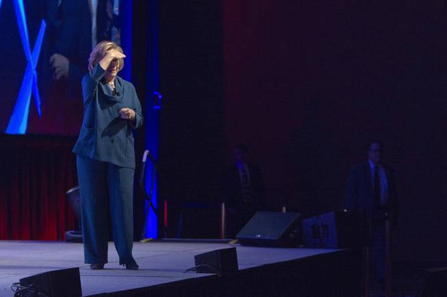 Former U.S. Secretary of State Hillary Rodham Clinton looks into the audience after an object was thrown on stage during her address to members of the Institute of Scrap Recycling Industries during their annual convention at the Mandalay Bay Convention Center Thursday, April 10, 2014. 