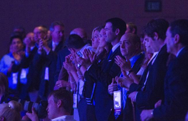 Members of the audience give an standing ovation as former U.S. Secretary of State Hillary Rodham Clinton continues with her speech after an object was thrown on stage at the Institute of Scrap Recycling Industries annual convention at the Mandalay Bay Convention Center Thursday, April 10, 2014. 