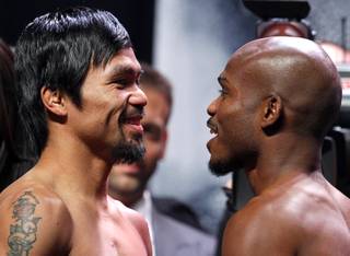 Boxer Manny Pacquiao, left, of the Philippines and undefeated WBO welterweight champion Timothy Bradley face off during an official weigh-in at the MGM Grand Garden Arena Friday, April 11, 2014. Pacquiao will challenge Bradley at the arena on Saturday. The fight is a rematch to a June 9, 2012 fight that Bradley won.