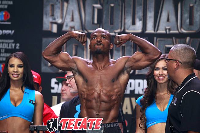 Undefeated WBO welterweight champion Timothy Bradley flexes on the scale during an official weigh-in at the MGM Grand Garden Arena Friday, April 11, 2014. Bradley will defend his title against Manny Pacquiao of the Philippines at the arena on Saturday. The fight is a rematch to a June 9, 2012 fight that Bradley won.