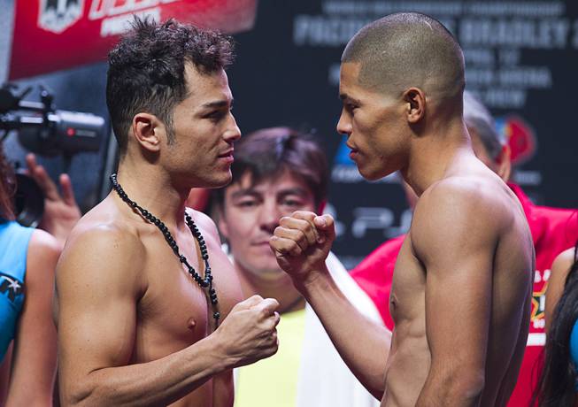 Super featherweight boxers Bryan Vazquez, left, of Costa Rica and Jose Felix of Mexico face off during an official weigh-in at the MGM Grand Garden Arena Friday, April 11, 2014. The boxers will fight for an WBA interim featherweight title.