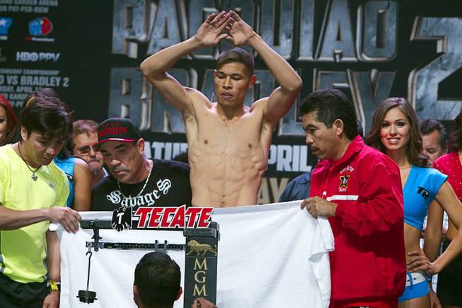 Super featherweight boxer Jose Felix of Mexico stands naked behind a towel during an official weigh-in at the MGM Grand Garden Arena Friday, April 11, 2014. Felix will fight Bryan Vazquez of Costa Rica for an WBA interim featherweight title at the arena on Saturday.