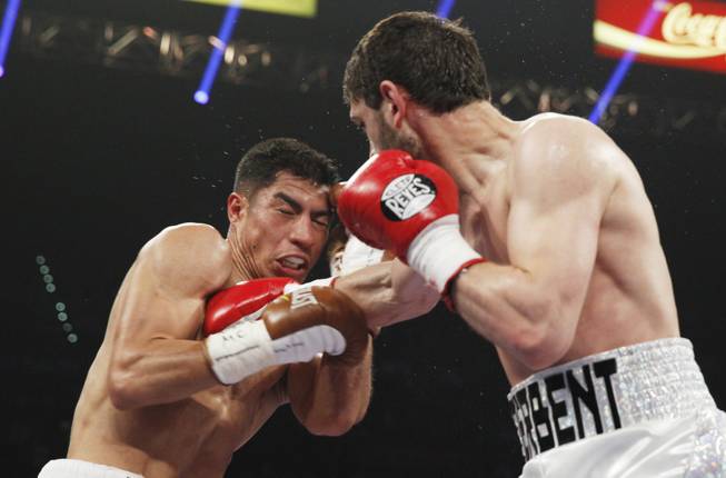 Jessie Vargas, left, is hit with a right by Khabib Allakhverdiev during their WBA interim super lightweight fight at the MGM Grand Garden Arena on Saturday, April 12, 2014.