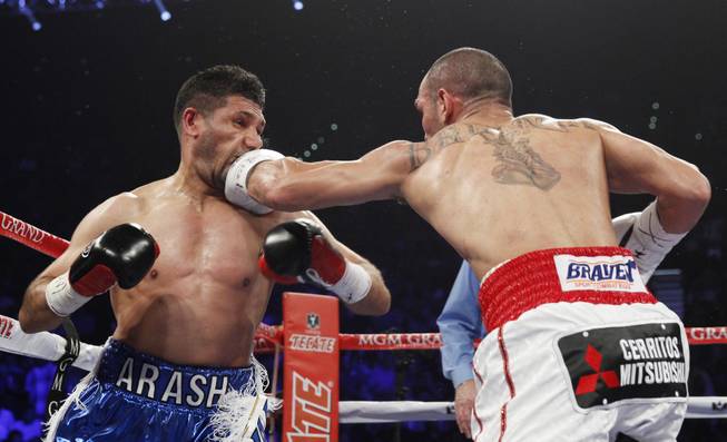 Arash Usmanee, left, is hit with a left from Ray Beltran during a 10-round lightweight fight at the MGM Grand Garden Arena on Saturday, April 12, 2014.