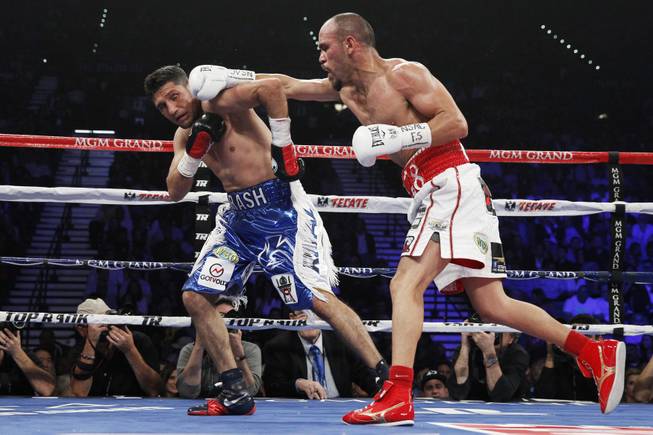 Arash Usmanee, left, is hit with a right from Ray Beltran during a 10-round lightweight fight at the MGM Grand Garden Arena on Saturday, April 12, 2014.