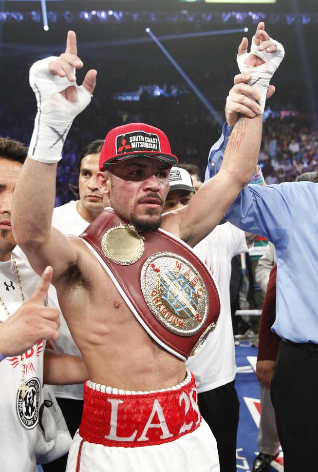 Ray Beltran of Mexico celebrates his unanimous victory over Arash Usmanee after their 12-round lightweight fight at the MGM Grand Garden Arena on Saturday, April 12, 2014.