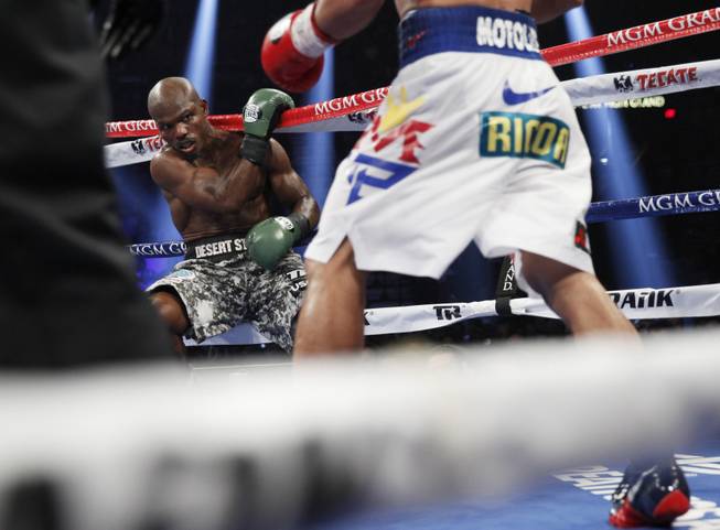 Manny Pacquiao knocks undefeated WBO welterweight champion Timothy Bradley into the ropes during their title fight at the MGM Grand Garden Arena on Saturday, April 12, 2014. Pacquiao won by unanimous decision.