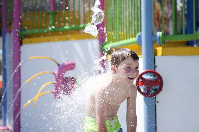 A boy enjoys the water fountains at the Kiddie Cove at Wet 'n' Wild during the first day of its weeklong spring break opening Saturday, April 12, 2014.