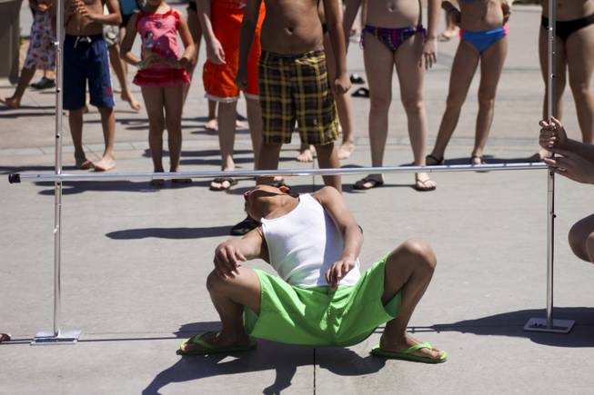 Michael Benson wins the limbo contest at Wet 'n' Wild with this attempt during the first day of its weeklong spring break opening Saturday, April 12, 2014.