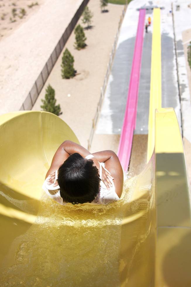 A woman goes down the Canyon Cliff slide at Wet 'n' Wild during the first day of its weeklong spring break opening Saturday, April 12, 2014.