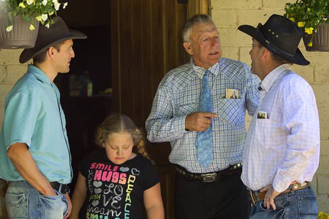 Cliven Bundy talks with family friend Rob Miller at the family ranch near Bunkerville Sunday, April 13, 2014. The Bureau of Land Management halted their roundup of Bundy family cattle under an agreement reached Saturday. David Lory VanDerBeek, an Independent American Party candidate for governor, looks on at left.