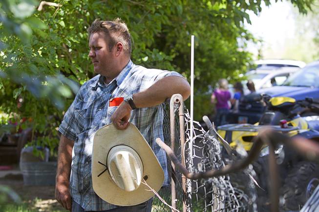 Dave Bundy, one of Cliven Bundy's son's, rests against a fence at the family ranch near Bunkerville Sunday, April 13, 2014. The BLM halted their roundup of Bundy family cattle under an agreement reached Saturday.