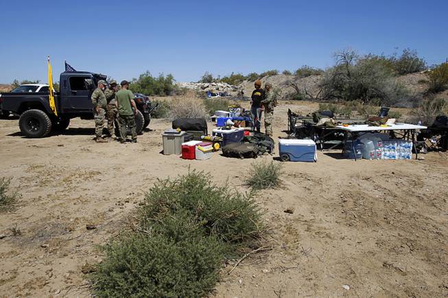 Militia-type volunteers return to a campsite near Bunkerville Sunday, April 13, 2014. The Bureau of Land Management halted their roundup of Bundy family cattle under an agreement reached Saturday.