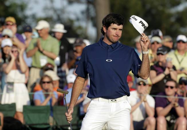 Bubba Watson tips his cap after putting on the 18th green during the third round of the Masters golf tournament Saturday, April 12, 2014, in Augusta, Ga.