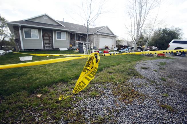 Pleasant Grove Police investigate the scene where  seven infant bodies were discovered and packaged in separate containers at a home in Pleasant Grove, Utah, Sunday, April 13, 2014.  According to the Pleasant Grove Police Department, seven dead infants were found in the former home of Megan Huntsman, 39. Huntsman was booked into jail on six counts of murder. (AP Photo/Deseret News, Jeffrey D. Allred) MANDATORY CREDIT