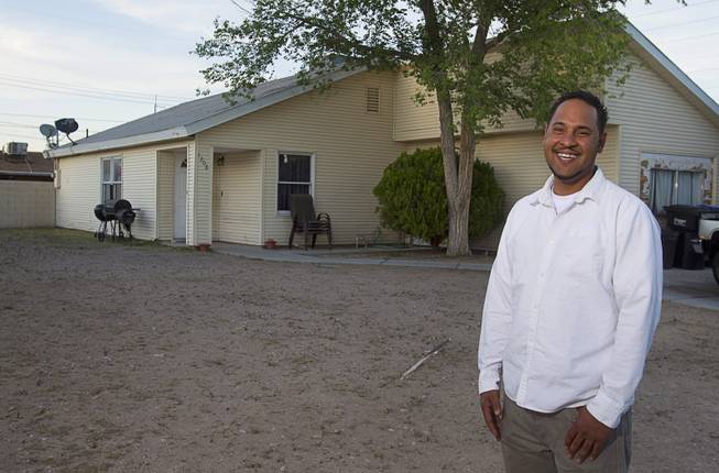 Damarlo Price poses in front of his home on Jackson Avenue Monday, April 14, 2014. Virginia Price, Damarlo's mother, was the first habitat for humanity recipient in Las Vegas. She received the home in 1991. Damarlo Price was raised in the home and still lives in it. His mother has moved to Texas.
