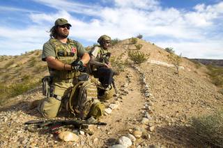 Reid Hendricks of Camden, Tenn., and Jim (no last name provided) of Las Vegas take up a position on a hill by Cliven Bundy's ranch near Bunkerville on Tuesday, April 15, 2014. Hendricks is a former Marine (honorably discharged) and has worked as a police officer and a high school history teacher, he said.