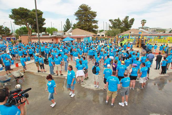 Volunteers begin to gather for the ribbon cutting after building a KaBoom playground for Child Haven Tuesday, April 15, 2014. Clark County Department of Family Services and Chicanos Por La Causa teamed up with volunteers from DirectTV and local businesses to rebuild the playground that was closed in 2012.