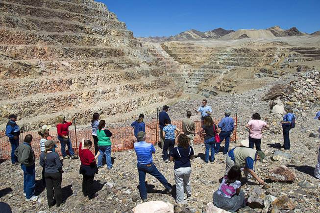 Teachers listen to Barrick's Tim Buchanan at the new Bullfrog Mine near Beatty during the 25th Annual Southern Nevada Earth Science Education Workshop Wednesday, April 16, 2014. The gold and silver mine was in operation from 1988 to 1999. The tour also included a trip the ghost town of Rhyolite. Teachers spent the first day of the workshop focused on classroom activities related to rocks and minerals.