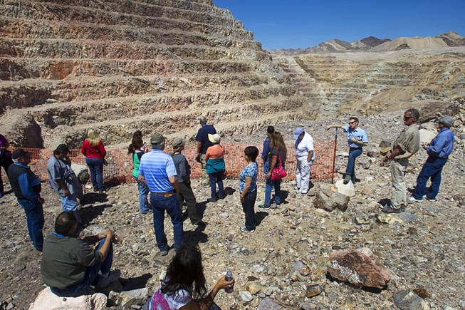 Teachers listen to Barrick's Tim Buchanan, at fence post, at the new Bullfrog Mine near Beatty during the 25th Annual Southern Nevada Earth Science Education Workshop Wednesday, April 16, 2014. The gold and silver mine was in operation from 1988 to 1999. The tour also included a trip the ghost town of Rhyolite. Teachers spent the first day of the workshop focused on classroom activities related to rocks and minerals.
