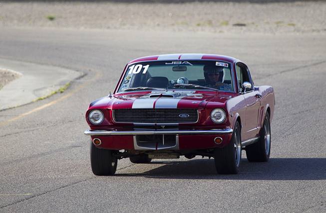 A 1966 Ford Mustang fastback is driven on a road course during the Mustang 50th Birthday Celebration at the Las Vegas Motor Speedway Thursday April 17, 2014.