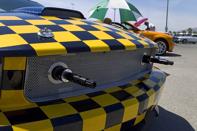 A customized late-model Mustang with fake machine guns is displayed during the Mustang 50th Birthday Celebration at the Las Vegas Motor Speedway Thursday, April 17, 2014.