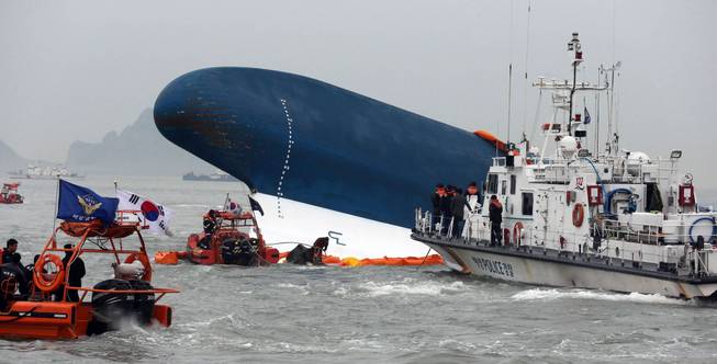 South Korean Coast Guard officers try to rescue missing passengers from a sunken ferry in the water off the southern coast near Jindo, south of Seoul, South Korea, Thursday, April 17, 2014. Fears rose Thursday for the fate of more than 280 passengers still missing more than 24 hours after their ferry flipped onto its side and filled with water off the southern coast of South Korea.