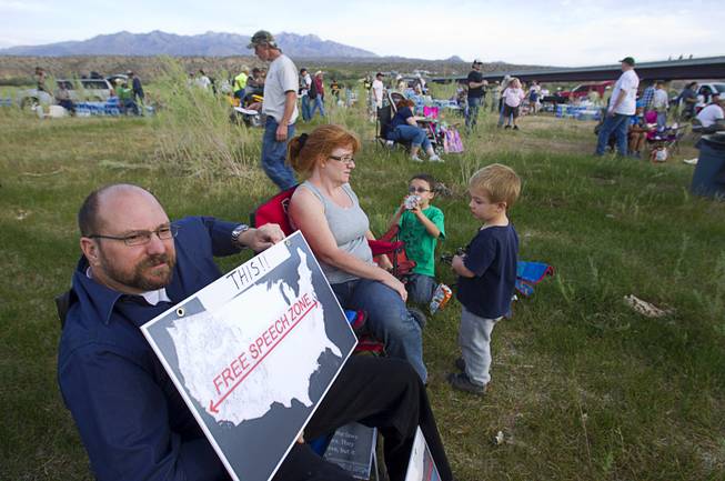 Attorney Marc Dion of Thousand Oaks, California holds a sign during a Bundy family "Patriot Party" near Bunkerville Friday, April 18, 2014. The family organized the party to thank people who supported rancher Cliven Bundy in his dispute with the Bureau of Land Management. The sign refers to "free speech zones" that the  the BLM set up during the cattle roundup operation.