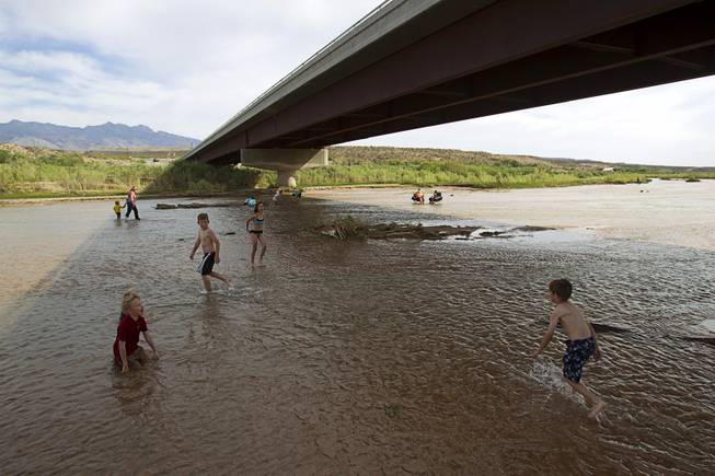 Children play in the Virgin River during a Bundy family "Patriot Party" near Bunkerville Friday, April 18, 2014. The family organized the party to thank people who supported rancher Cliven Bundy in his dispute with the Bureau of Land Management.