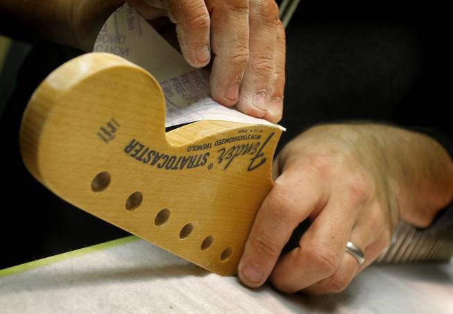 A Fender Stratocaster head stock is sanded in the Fender Custom Shop at the factory in Corona, Calif. on Tuesday, Oct. 15, 2013. Leo Fender developed the instrument in a small workshop in Fullerton, Calif. six decades ago.