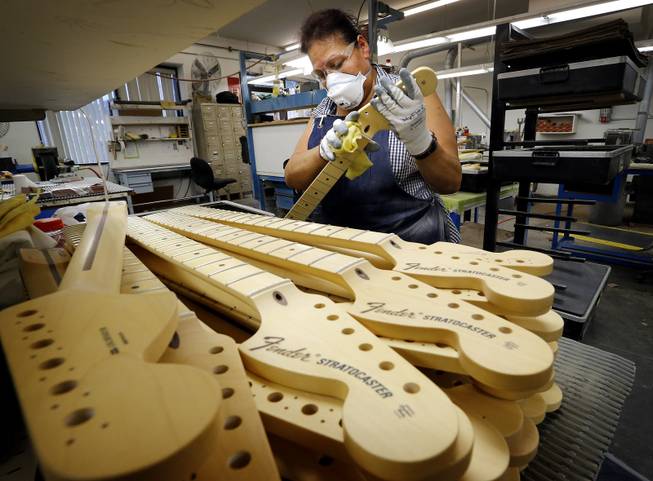 Fender Stratocaster necks are prepared for assembly at the Fender factory in Corona, Calif. on Tuesday, Oct. 15, 2013. The instrument, used by countless professional and amateur musicians, celebrates it's 60th anniversary in 2014.