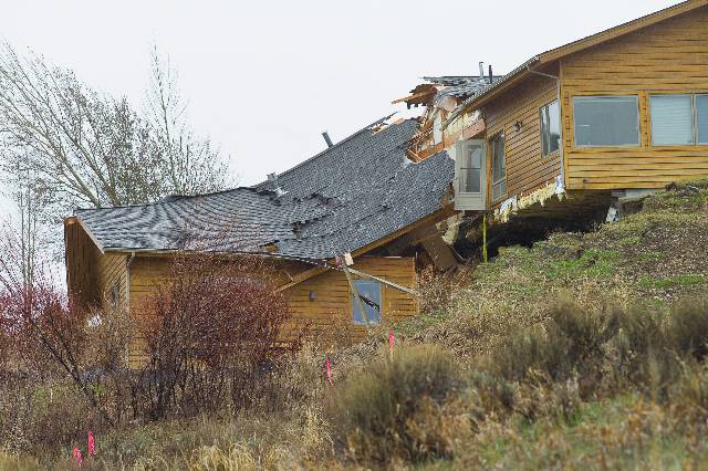 A house breaks apart as a slow-moving landslide in Jackson, Wyo. advances downhill on Friday, April 18. 2014. The slide has cut off access to a 60-person neighborhood and has threatened town utilities, including a water line.