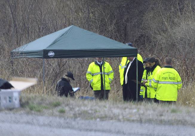 Massachusetts State Police stand along Interstate 190 where police said a child's body was found Friday, April 18, 2014, near Sterling, Mass. Jeremiah Oliver was last seen by relatives in September 2013 but wasn't reported missing until December. His mother Elsa Oliver and her boyfriend, Alberto Sierra, are charged in the case.